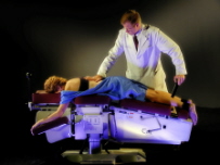 chiropractor helping patient with back pain